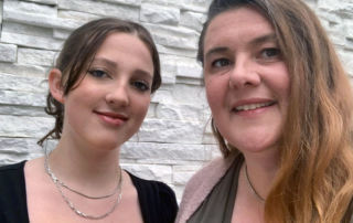 A mother and daughter pose for a selfie