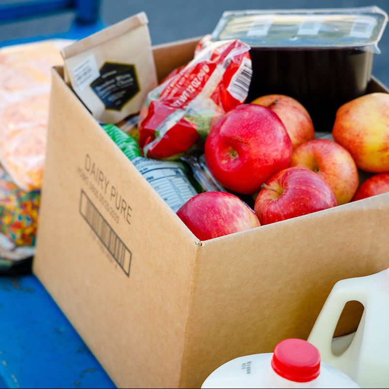 A cart full of healthy foods such as apples and milk