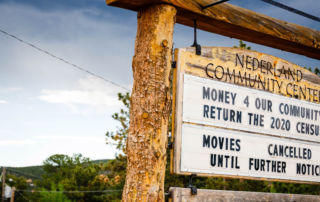 A wooden letterboard lists off the services available at the Nederland Community Center