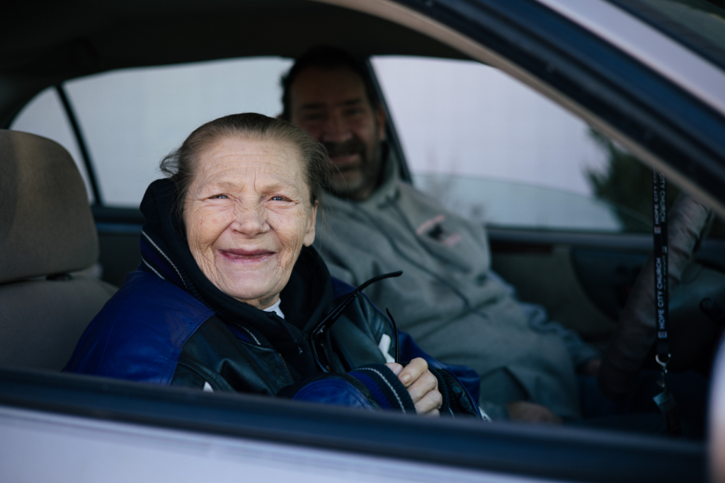 older woman sitting in her car