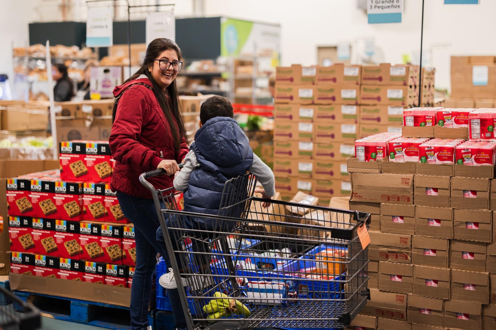 woman smiling in feeding families with her child
