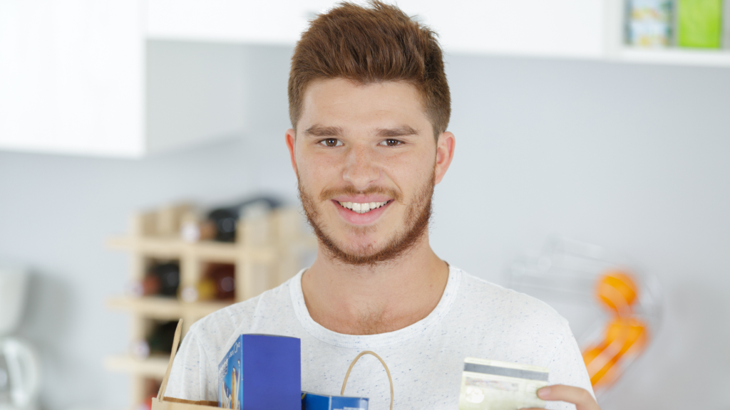 college student with groceries and card